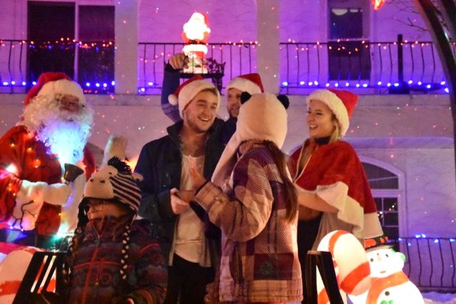 Santa and assistants welcoming neighbours.