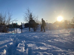 [Kìchì Sìbì Winter Trail in use by Skiers, Ottawa Mosque and its parking lot in background]