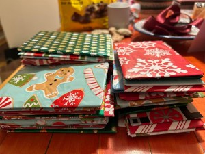 [Stacks of gift cards wrapped in festive paper]